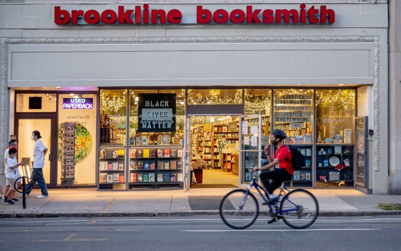 a person riding a bike in front of a store
