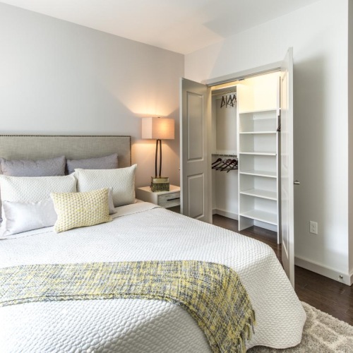 a bedroom with a bed and a closet