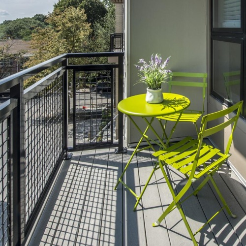 a table with flowers on it on a balcony